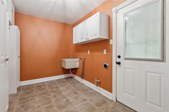 clothes washing area featuring washer hookup, cabinet space, light tile patterned floors, baseboards, and hookup for an electric dryer