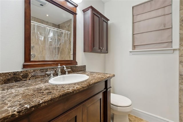 bathroom featuring baseboards, toilet, vanity, and a tile shower