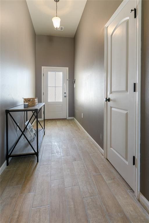 doorway to outside featuring visible vents and baseboards