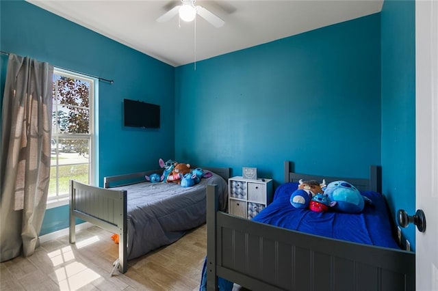 bedroom featuring a ceiling fan and wood finished floors