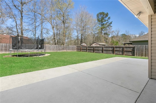 view of patio / terrace with a trampoline and a fenced backyard