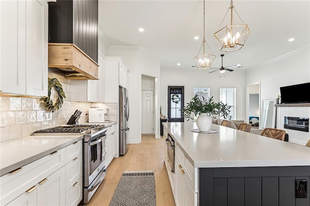 kitchen featuring a large island, decorative backsplash, stainless steel appliances, and crown molding