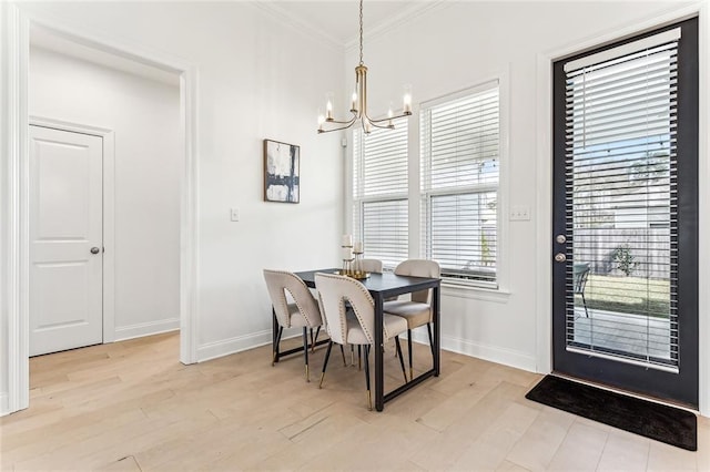 dining space with baseboards, light wood-style floors, a chandelier, and crown molding