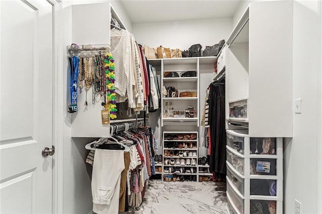 spacious closet featuring marble finish floor