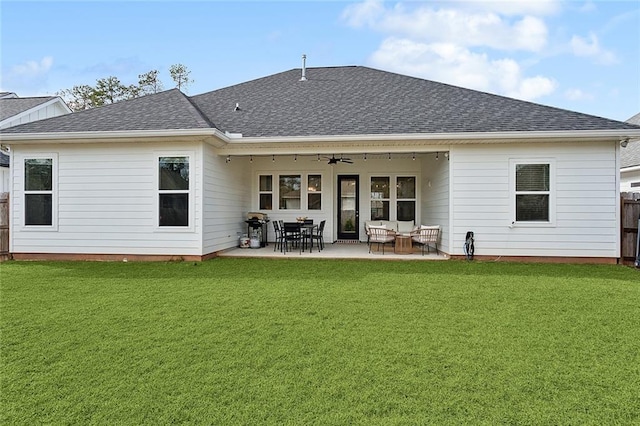 back of house featuring a yard, fence, a ceiling fan, and roof with shingles