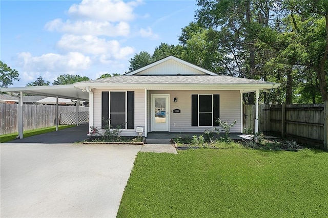 bungalow with covered porch, driveway, a front lawn, and fence