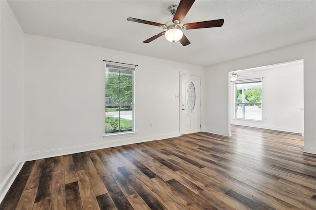 interior space featuring a ceiling fan, a healthy amount of sunlight, and wood finished floors