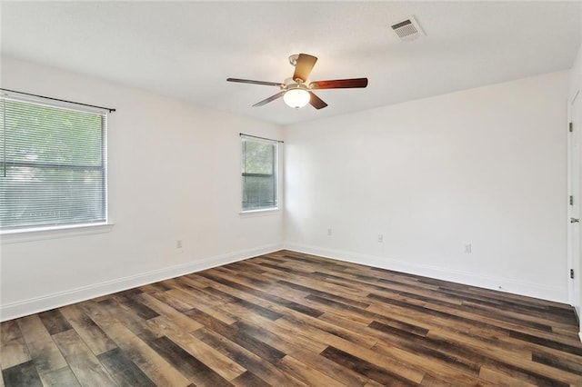 unfurnished room with wood finished floors, visible vents, a ceiling fan, and a healthy amount of sunlight