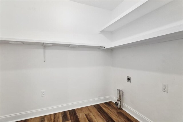 clothes washing area featuring dark wood-style floors, baseboards, hookup for an electric dryer, and laundry area