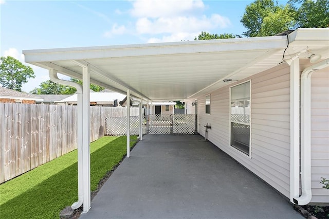 view of patio / terrace with fence and an attached carport