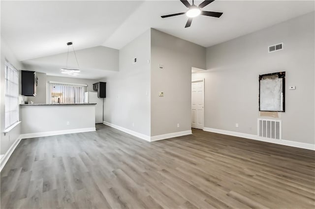 unfurnished living room with visible vents, lofted ceiling, and wood finished floors