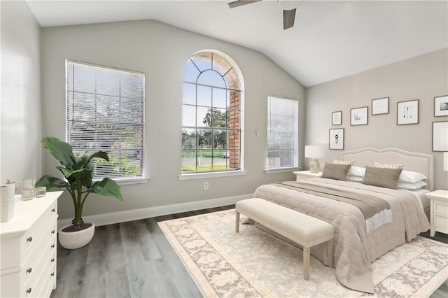 bedroom featuring a ceiling fan, lofted ceiling, wood finished floors, and baseboards