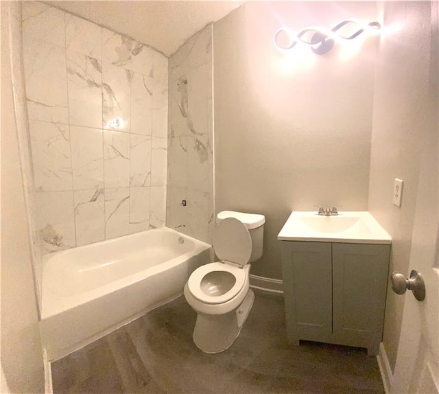 bathroom with toilet, vanity, and baseboards