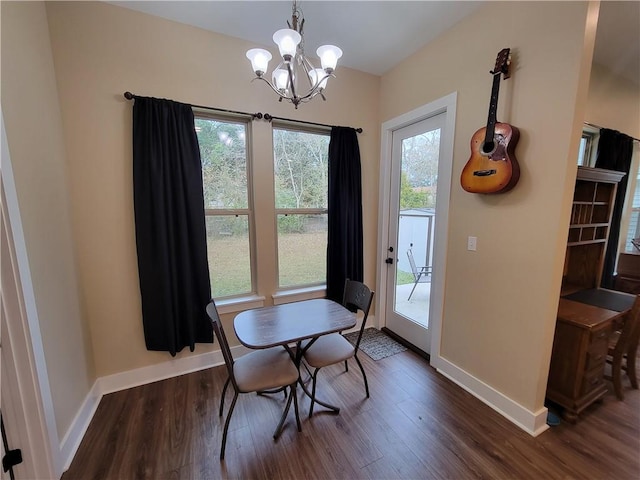 dining room with an inviting chandelier, baseboards, and dark wood-style flooring