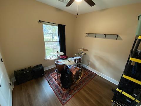 dining area with a ceiling fan, wood finished floors, and baseboards