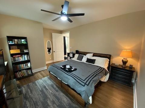 bedroom featuring ceiling fan, baseboards, and wood finished floors