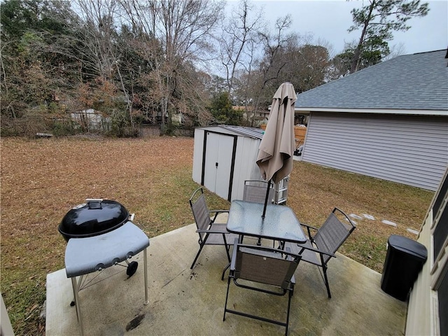 view of patio / terrace with outdoor dining space, an outbuilding, and a shed