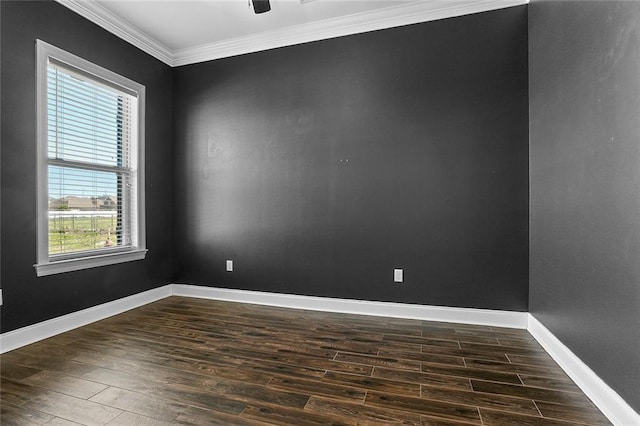 empty room featuring dark wood-style flooring, ceiling fan, baseboards, and ornamental molding