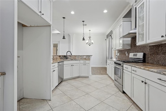 kitchen with tasteful backsplash, white cabinetry, appliances with stainless steel finishes, and stone countertops