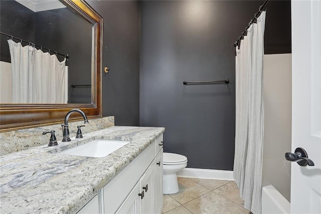 bathroom with tile patterned flooring, toilet, vanity, and baseboards