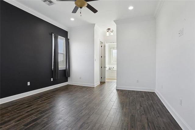 unfurnished room with dark wood-type flooring, ornamental molding, visible vents, and ceiling fan