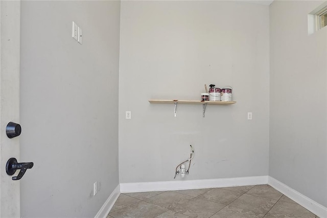 laundry room featuring light tile patterned floors and baseboards