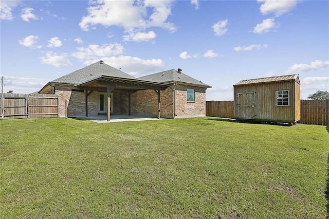 back of property with a fenced backyard, an outdoor structure, a storage shed, a patio area, and a lawn