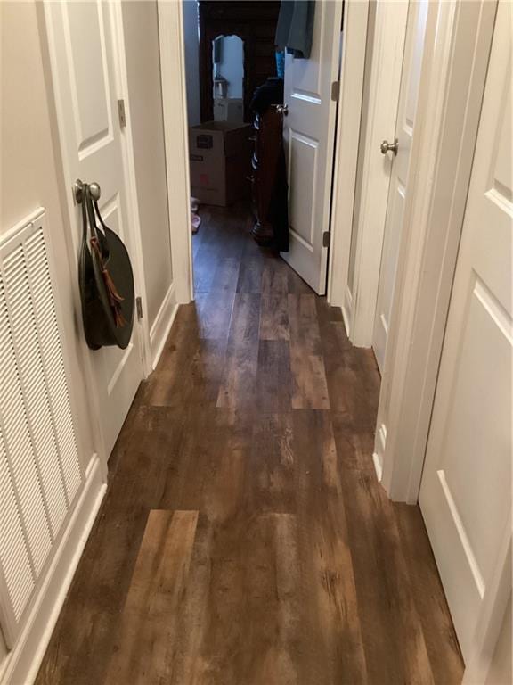 corridor featuring visible vents and dark wood-style flooring