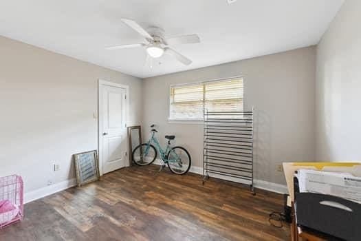 1913 Satsuma St, Metairie, LA 70001 - misc room with baseboards, a ceiling fan, and wood finished floors