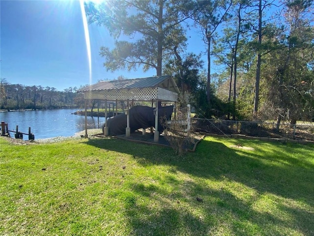 view of yard featuring fence and a water view