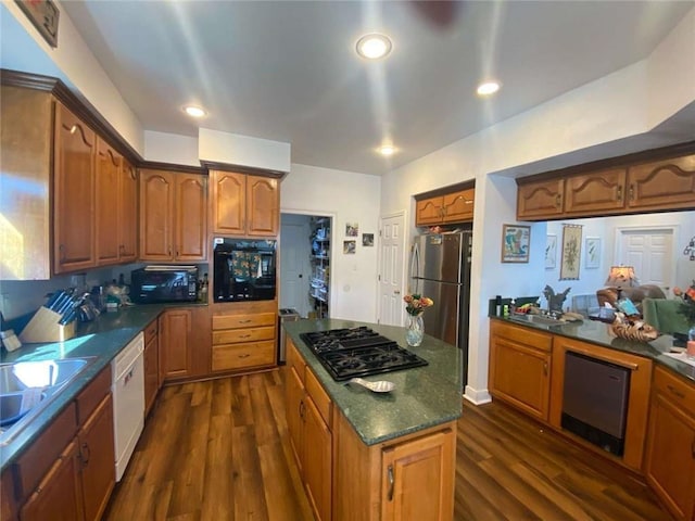 kitchen with recessed lighting, black appliances, dark wood-type flooring, brown cabinets, and a center island