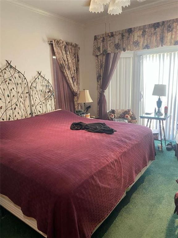 bedroom with a ceiling fan, crown molding, and carpet