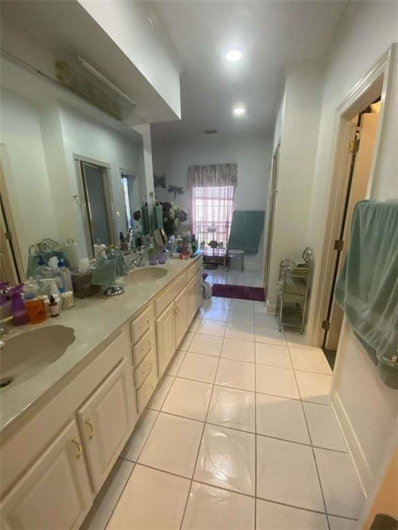 bathroom with a sink, recessed lighting, double vanity, and tile patterned flooring