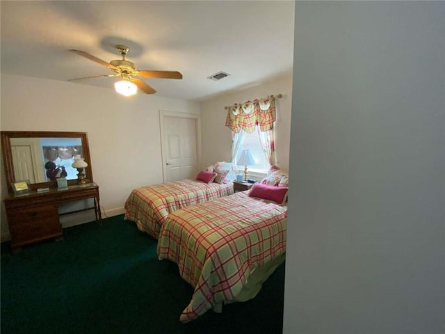 carpeted bedroom with visible vents, baseboards, and ceiling fan