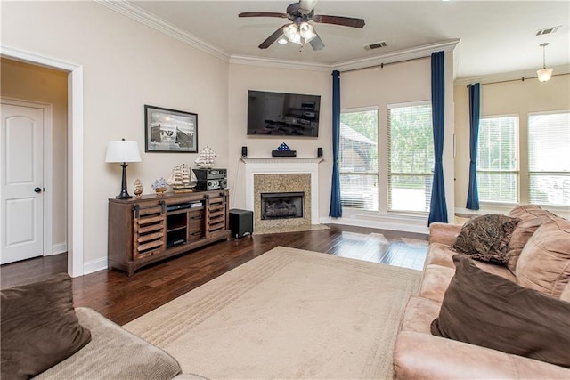 living room featuring a premium fireplace, wood finished floors, ceiling fan, and ornamental molding