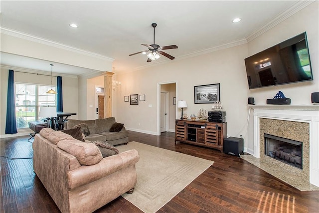 living area featuring ceiling fan, dark wood-style floors, a high end fireplace, and crown molding