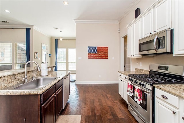 kitchen featuring a sink, white cabinetry, appliances with stainless steel finishes, crown molding, and a healthy amount of sunlight