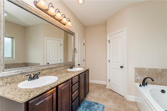 bathroom with a sink, baseboards, a tub with jets, and double vanity