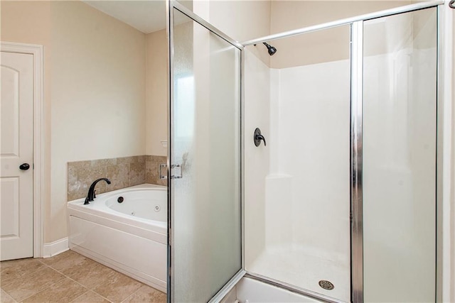 full bath with tile patterned floors, a jetted tub, and a stall shower