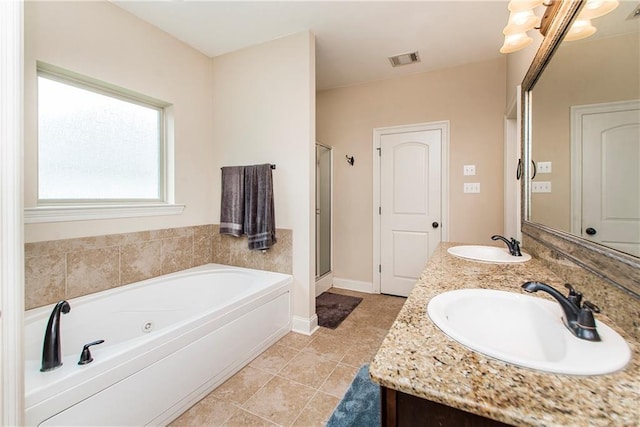 full bath featuring double vanity, a bath, visible vents, and a sink