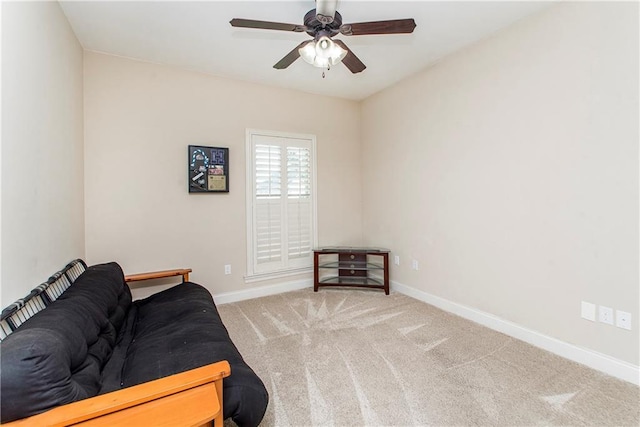 sitting room with baseboards, a ceiling fan, and carpet flooring