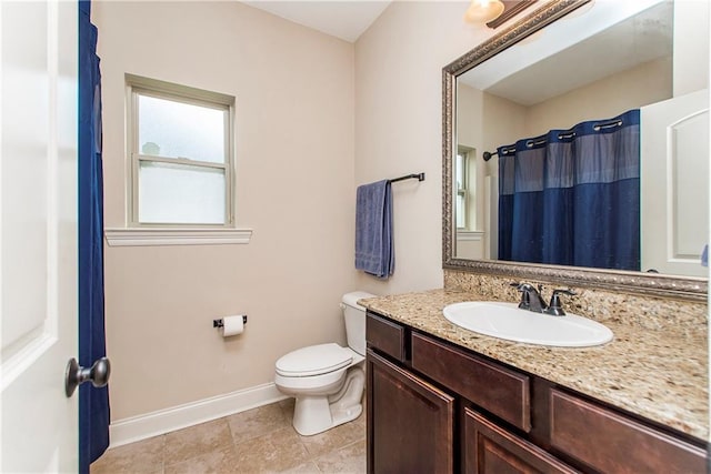 full bathroom featuring baseboards, toilet, vanity, and tile patterned flooring