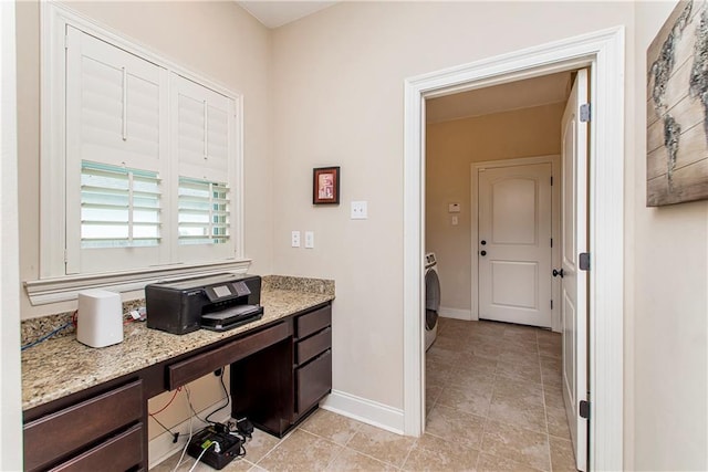 bathroom with baseboards, washer / dryer, and tile patterned flooring