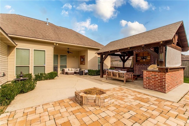 view of patio / terrace with a gazebo, area for grilling, an outdoor living space with a fire pit, and a ceiling fan