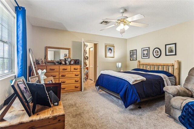 carpeted bedroom with visible vents and ceiling fan