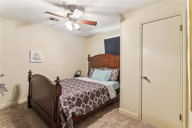 carpeted bedroom with ceiling fan and visible vents