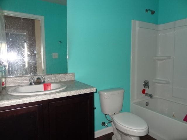 bathroom featuring vanity,  shower combination, toilet, and baseboards