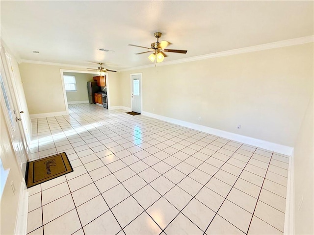 empty room featuring visible vents, baseboards, ornamental molding, light tile patterned flooring, and a ceiling fan