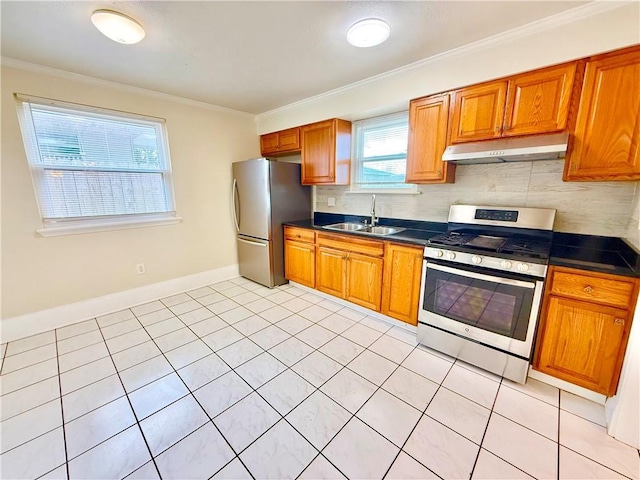 644 Willowbrook Dr, Gretna, LA 70056 - kitchen with stainless steel appliances, a sink, under cabinet range hood, dark countertops, and backsplash