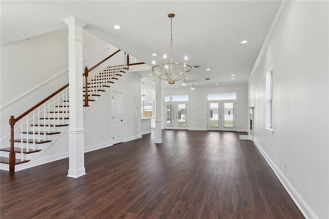 unfurnished living room with crown molding, stairs, baseboards, and dark wood-style flooring